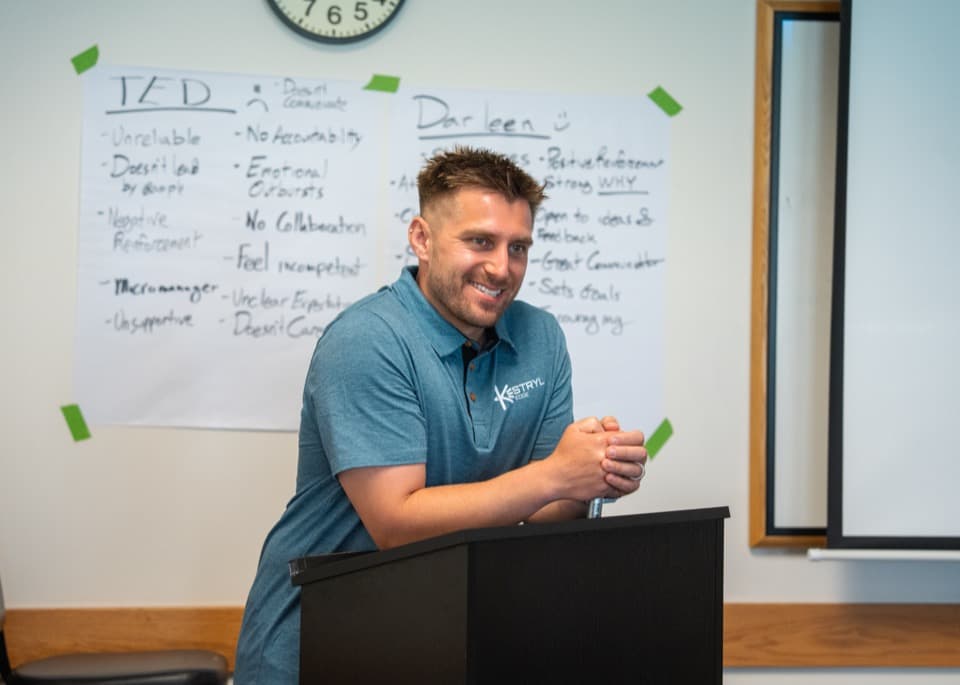 Dan Korus facilitating a leadership exercise at the whiteboard